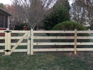 A wooden gate with horizontal slats in a natural outdoor setting.
